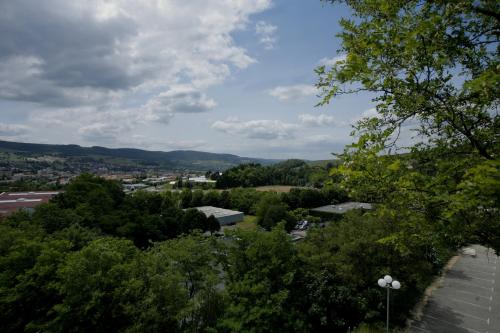 a view of a city from the top of a tree at The Originals City, Hôtel L'Acropole, Saint-Etienne Sud in La Ricamarie