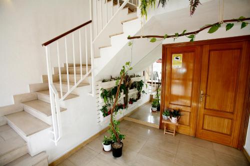 a hallway with stairs and potted plants at Hotel Ripa in Bilbao