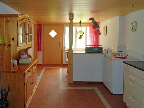 a kitchen with white cabinets and a counter top at Ferienwohnung im Grünen in Grindelwald