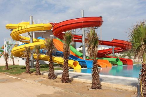 a water slide at a water park with palm trees at Vincci Helios Beach in Midoun