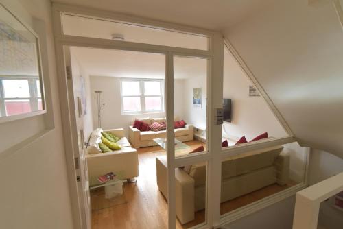 a view of a living room with a mirror at Beach Central with Allocated Parking and Patio in Brighton & Hove