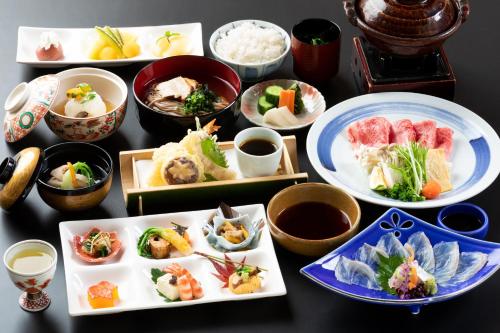 a group of plates of food on a table at Yufuin Santoukan in Yufuin