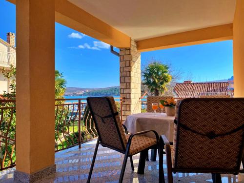 a patio with a table with a view of the ocean at Apartments Nevenka K. in Čižići