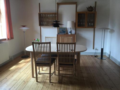 a dining room with a table and four chairs at Ørstedsgade, Sønderborg in Sønderborg