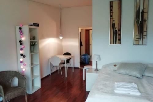 a living room with a bed and a table with chairs at Nice apartment in Vaasa in Vaasa