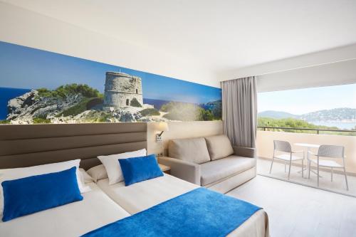 
a hotel room with a large bed and a painting on the wall at Invisa Hotel Club Cala Verde in Es Figueral Beach

