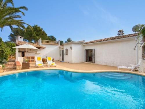 a swimming pool in front of a house at Holiday Home La Concha by Interhome in Balcon del Mar