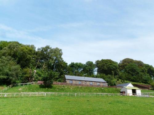 a barn in the middle of a field at Holiday Home Cwm Tawel by Interhome in Pentyrch