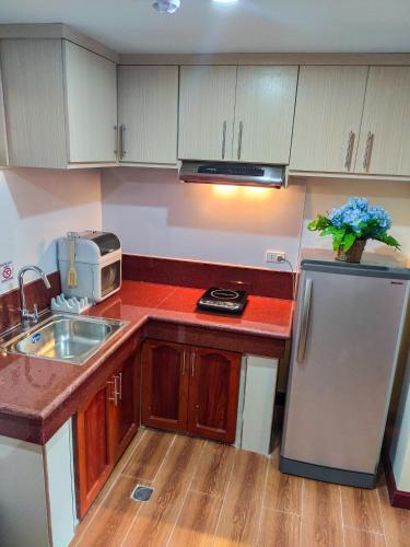 a kitchen with a sink and a refrigerator at 456 Hotel in Baguio