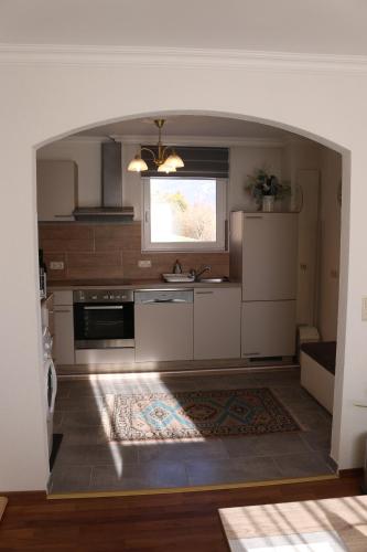 a kitchen with an archway in the middle of a room at Villa Schloss in Wolfsberg