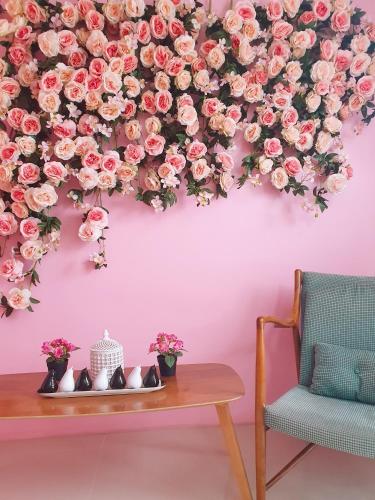 a bunch of pink roses hanging from a wall at BLUE OCEAN BOUTIQUE HOTEL - Boracay Island in Boracay