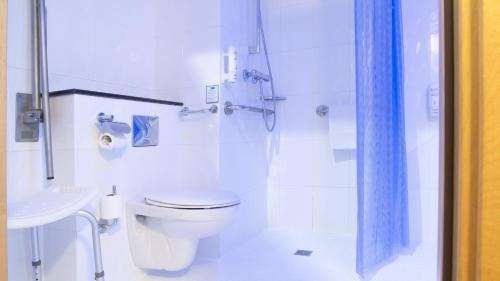 a white bathroom with a toilet and a shower at Holiday Inn Express Valencia Bonaire by IHG in Aldaya