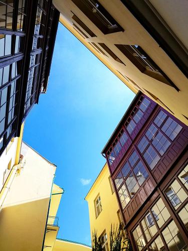 a view of the sky from between two buildings at Hotel Zlatá Váha in Prague