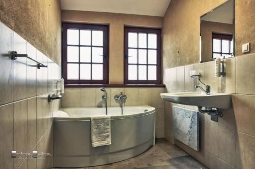 a large bathroom with a tub and a sink at Centrum Konferencyjne Zamek in Szczecinek