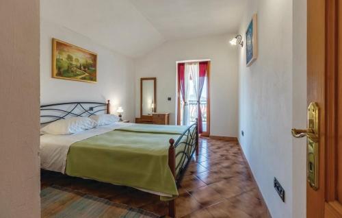 a bedroom with a bed with a green bedspread at Holiday House Klarin with Sea View in Preko