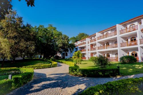 an apartment building with a walkway in front at Sanctum Inle Resort in Nyaung Shwe