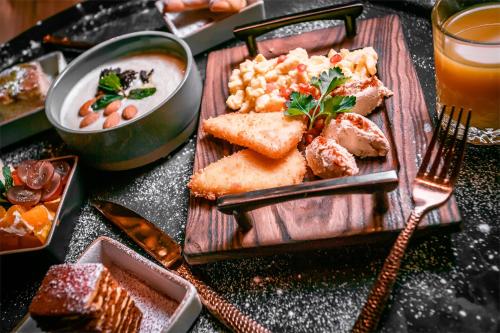 a table with a plate of food on a table at Grand Sapphire Hotel in Almaty