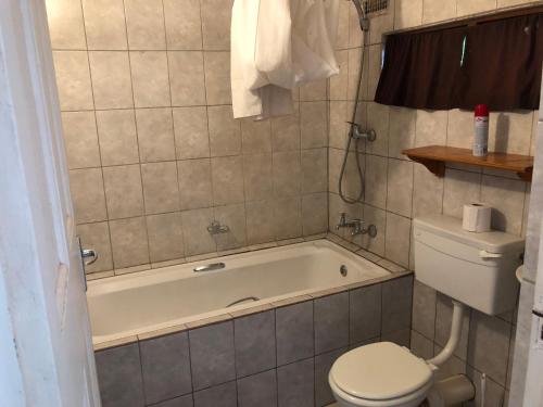 a bathroom with a tub and a toilet and a sink at Carsdale country lodge in Empangeni