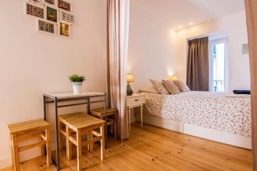 リスボンにあるNew Apartment Bairro Altoの小さなベッドルーム(ベッド1台、テーブル付)