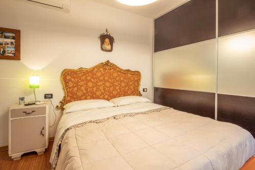 a bedroom with a large bed and a clock on the wall at Realkasa Senzanome Flat in Bologna