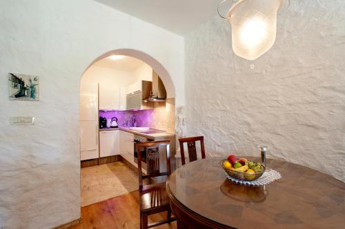 a kitchen with a table with a bowl of fruit on it at Villa Castello Rausch in Poreč