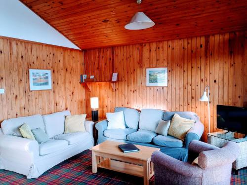 a living room with two couches and a coffee table at Loch Monzievaird Chalets in Crieff