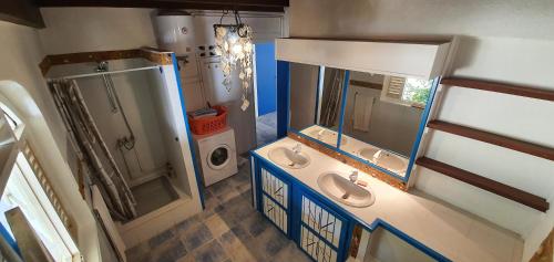 an overhead view of a bathroom with two sinks and a shower at Villa la GAIA in Grand-Bourg