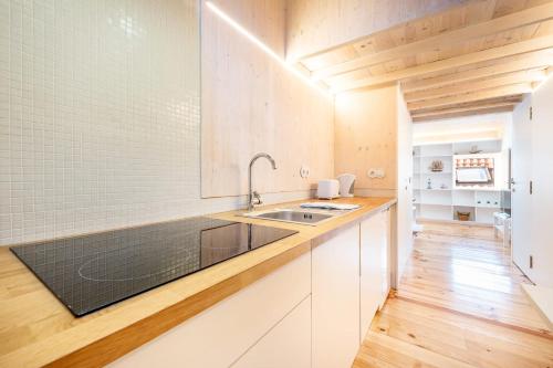 a kitchen with white cabinets and a sink at GuestReady - Beco do Garcês Apartment in Lisbon