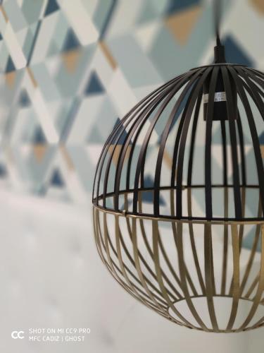 a metal orb light fixture hanging from a ceiling at Hotel Doña Blanca in Jerez de la Frontera