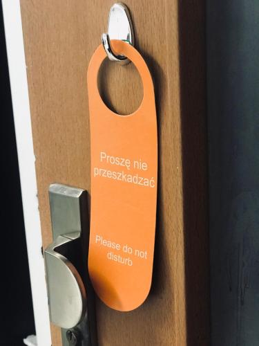 an orange tag is attached to a door at Wilcza Apartments in Warsaw