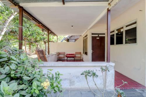 an open porch of a house with plants at Omah Nggunung Cafe & Homestay in Yogyakarta