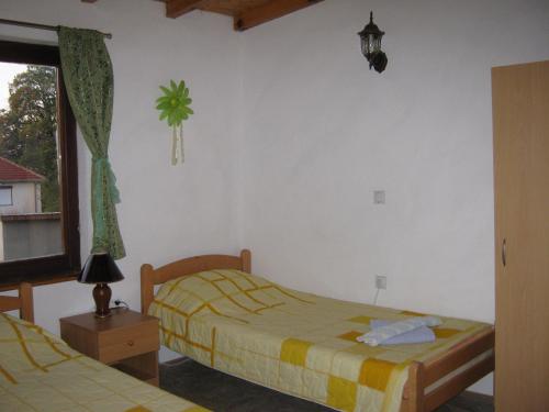 a bedroom with two beds and a window at Risto's Guest House in Ohrid