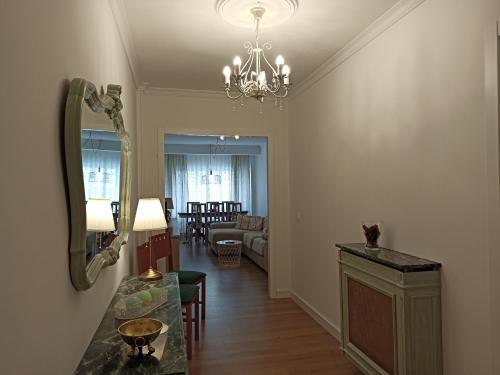 a living room with a table and a mirror at CARMELA in Santiago de Compostela