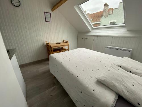 - une chambre avec un grand lit et une fenêtre dans l'établissement Une virée à Dunkerque entre ville et plage, à Dunkerque