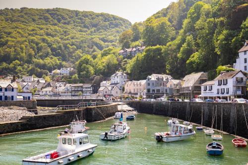 a group of boats are docked in a river at The Bath Hotel in Lynmouth