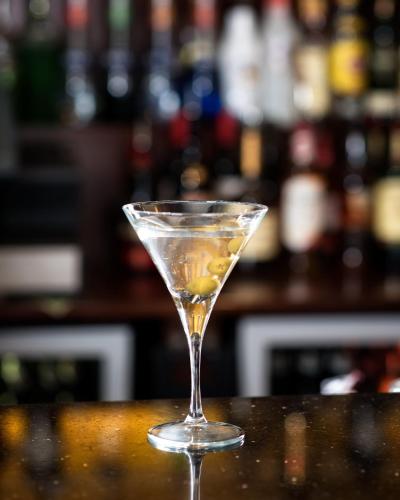 a martini glass sitting on a counter in a bar at Camden Court Hotel in Dublin