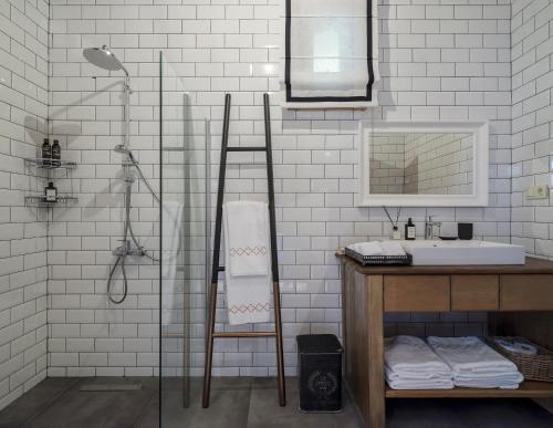 a white bathroom with a sink and a shower at Simurg Inn in Çanakkale