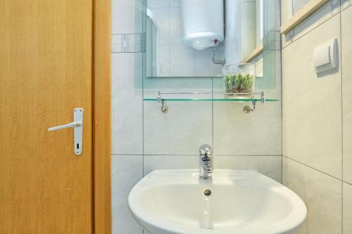 a bathroom with a sink and a mirror at Apartments Zelic Tucepi in Tučepi