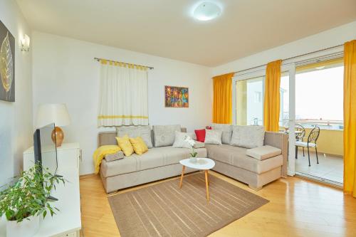 a living room with a couch and a table at Apartments Zelic Tucepi in Tučepi