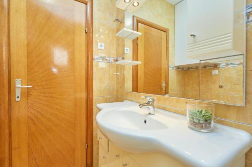a bathroom with a sink and a mirror at Apartments Zelic Tucepi in Tučepi