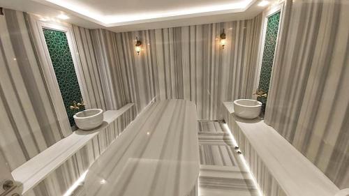 a bathroom with two sinks and two windows at Sarnic Premier Hotel in Istanbul