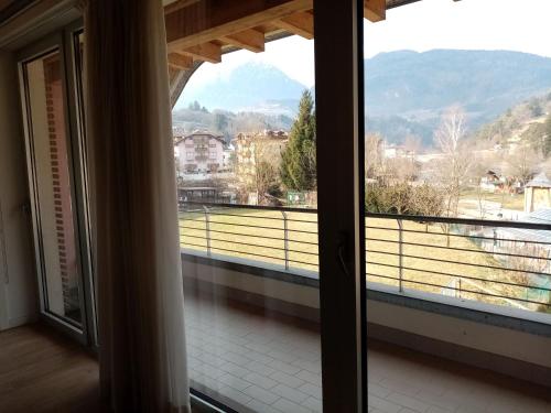 a room with a large window with a view at MONTE MISONE 2.0 in Comano Terme