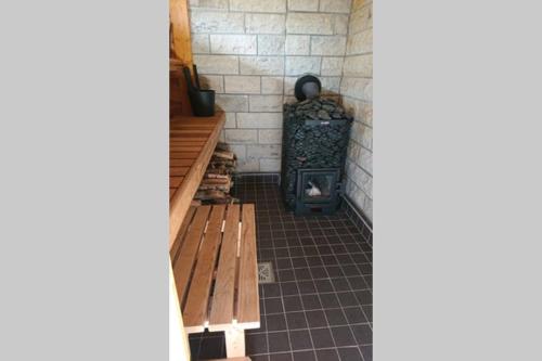 a room with a fireplace and a wood stove at Captain Alexandri Cottage by the Sea in Kõiguste