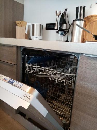 a dishwasher with a dish rack inside of it at MONTE MISONE 2.0 in Comano Terme