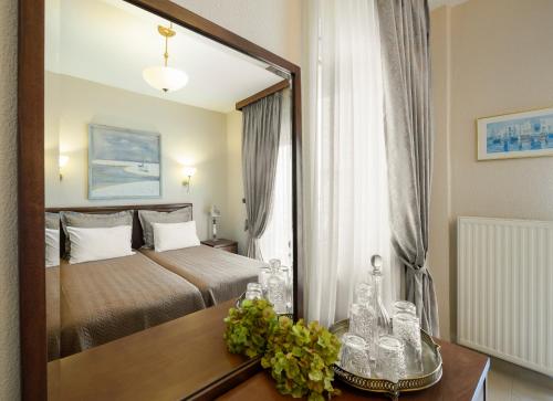 Ένα ή περισσότερα κρεβάτια σε δωμάτιο στο Ξενοδοχείο Αλκυονίς