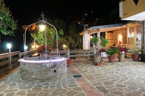 a fountain in the middle of a patio at night at B & B Il Campanile in Perdifumo