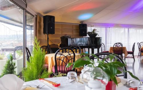 a restaurant with tables and chairs and a balcony at Hotel Atlantic in Arona