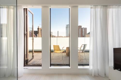 a sliding glass door with a view of a balcony at Ruby Lucy Hotel London in London