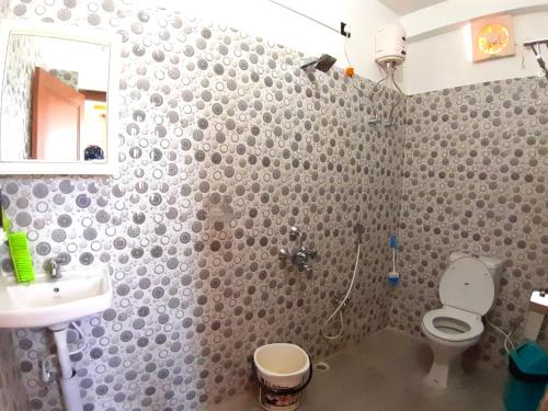 a bathroom with a toilet and a sink at Abhi's homestay in Port Blair