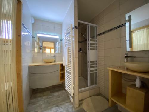a bathroom with two sinks and a shower at Monster Chalets in Le Bettaix